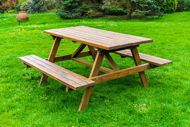 istock Wooden picnic table and bench in garden 1140446306