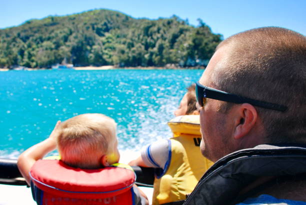 Children on Boat Trip in the Abel Tasman National Park, New Zealand Children on boat trip on a water taxi. This image is taken in the Abel Tasman National Park in the Tasman District of New Zealand's South Island. abel tasman national park stock pictures, royalty-free photos & images
