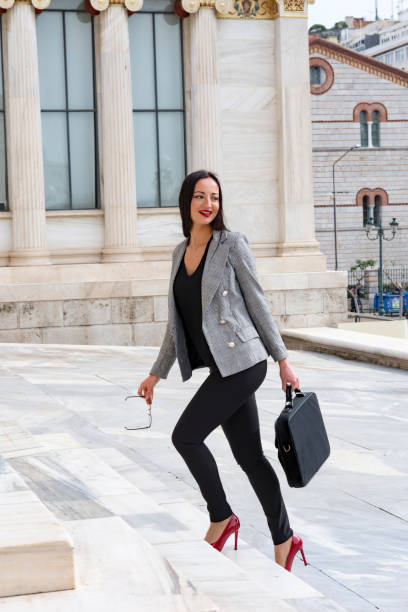 istock Happy woman climbs marble stairs 1140449569