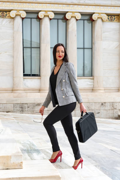 istock Happy woman climbs marble stairs 1140449678