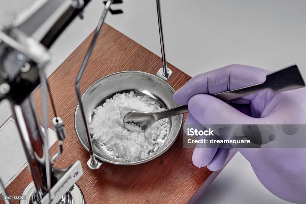 Pharmacist or scientist preparing medicine using precision weighing Pharmaceutical Compounding Stock Photo