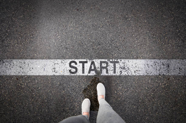 istock Woman standing next to the word start 1140458725