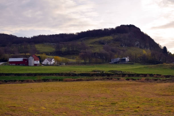 istock Norwegian pastures in the fall. Old stone fence. Typical Norwegian farm. 1140458895