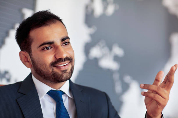 Businessman talking in room with map on wall