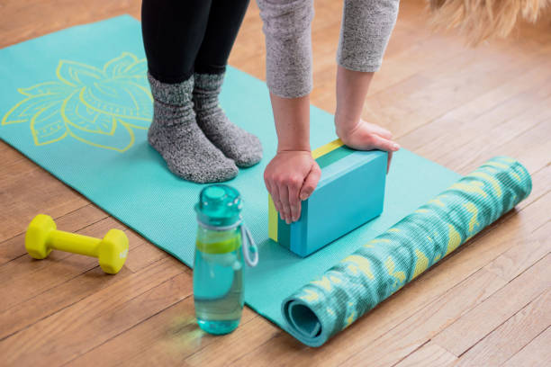 Girl with hands on yoga block stretching