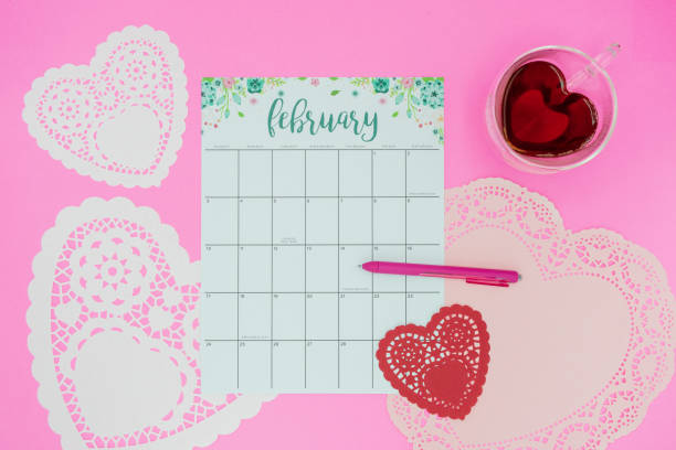 istock February calendar flat lay on pink background 1140461305