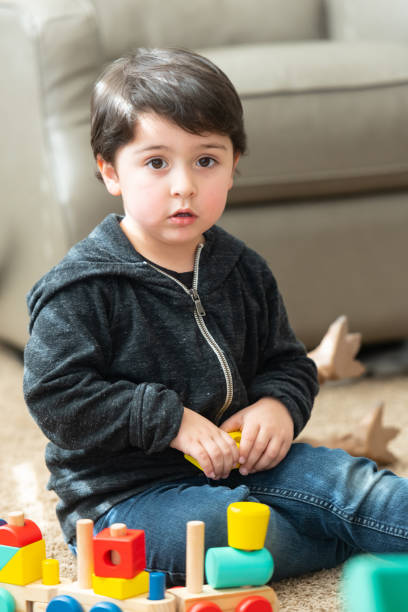 istock Hispanic three years old little child boy playing with his toys 1140462016
