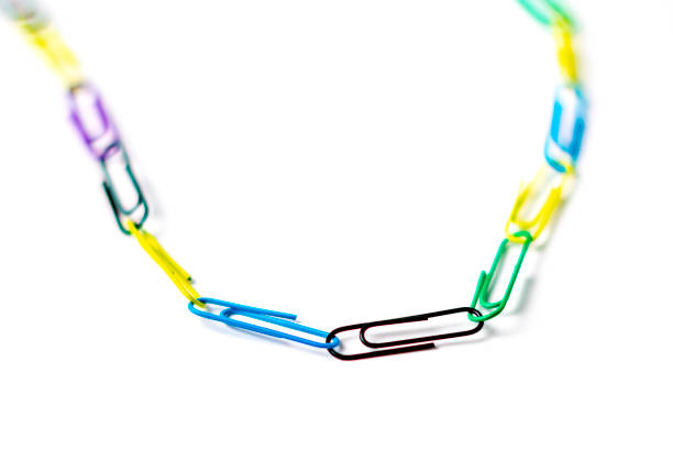 colorful paper clips chain in form of snake on the table surface