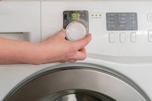 istock womans hand prepare washing machine and press buttons 1140465046