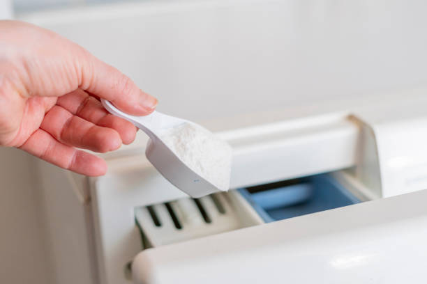 istock hand pour washing powder in the machine in laundry 1140465182