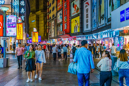 This is a view of Chinese people shopping at Dongmen Pedestrian Street the main shopping street in the downtown area at night on October 28, 2018 in Shenzhen