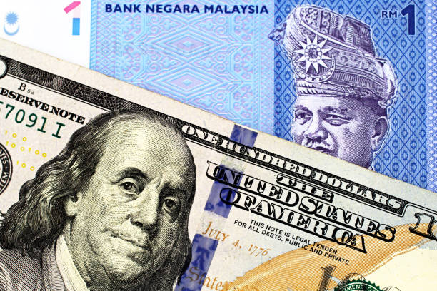 un conto ringgit malese con una fattura americana da cento dollari - malaysian ringgit foto e immagini stock