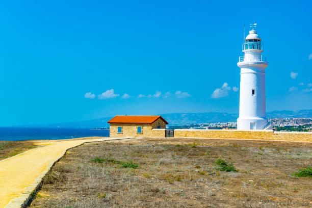 istock White lighthouse situated in Paphos Archaeological Park on Cyprus 1140466554