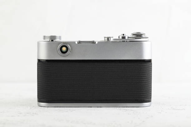 istock The old 35 mm film rangefinder camera on white cement background. 1140466631