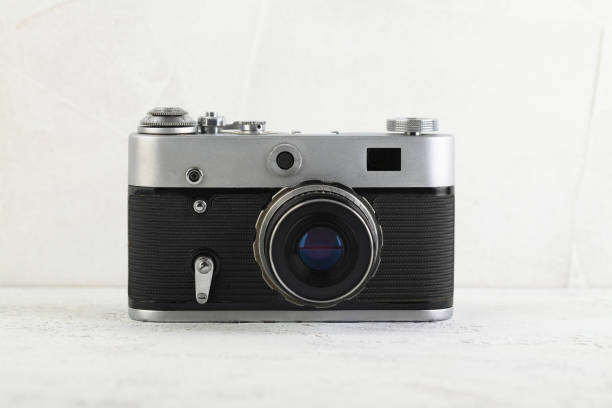 istock The old 35 mm film rangefinder camera on white cement background. 1140466632