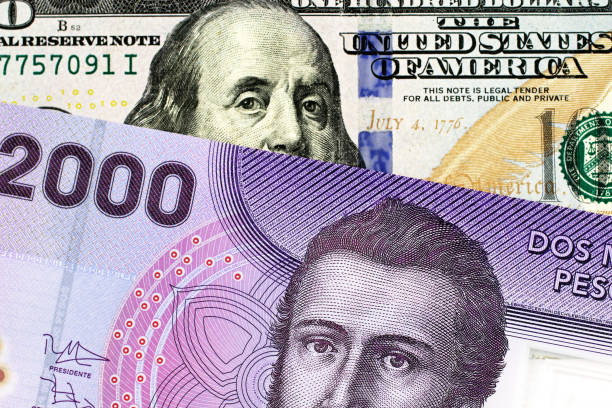 istock A Chilean 2000 peso bank note with an American one hundred dollar bill 1140468391