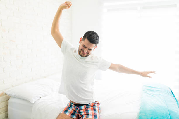 istock Man Giving A Stretch In Bed 1140469422