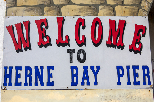 Kent, UK - February 21st 2019: A Welcome sign on Herne Bay Pier in the coastal town of Herne Bay in Kent, England.