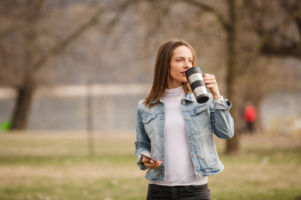 istock Young woman walking with coffee cup in hand 1140471501