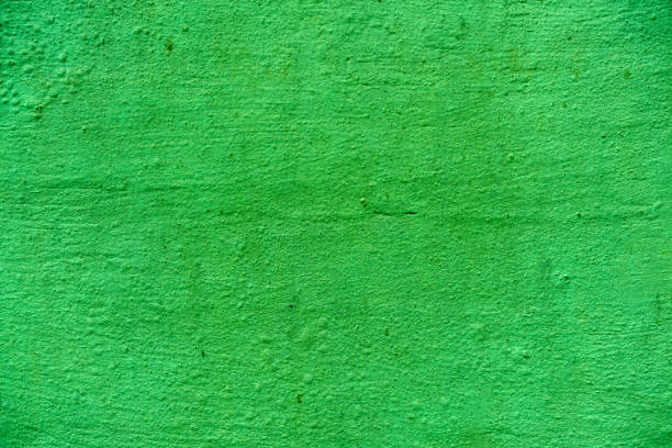 istock Uneven concrete wall painted in different colors as a background 1140473036