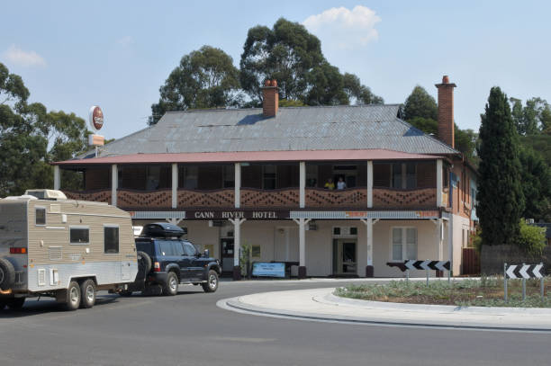 Cann River, Victoria - March 03, 2019: Car pulling a caravan outside Cann River Hotel in Victoria. It's a popular stopping point for traveler's between Melbourne and Sydney using the Princes Highway route.