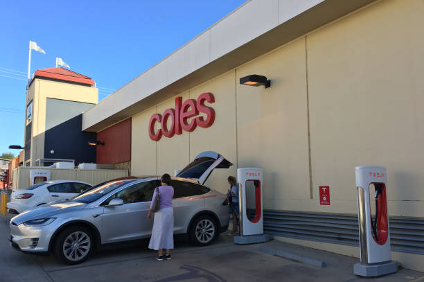 Tesla plug-in electric car Model X been charged by a Supercharger network in Coles Supercharger station Melbourne, Australia - March 01, 2019: Tesla plug-in electric car Model X been charged by a Supercharger network in Coles Supercharger station.Tesla is one of the best plug-in cars manufacturer in the world elon musk stock pictures, royalty-free photos & images