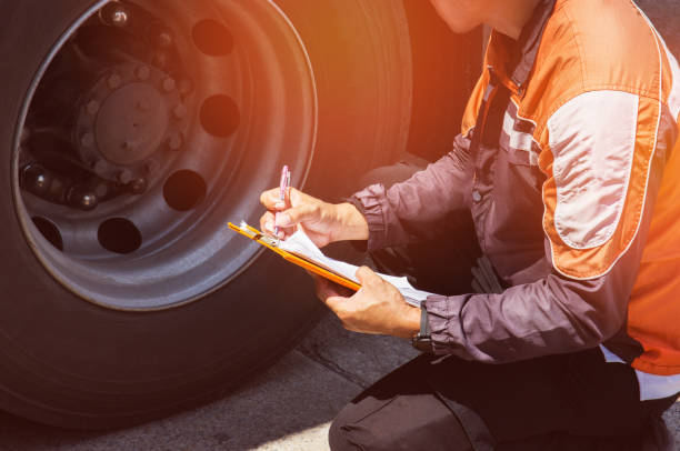 Truck inspecting Truck driver is inspecting a truck tires bkk stock pictures, royalty-free photos & images