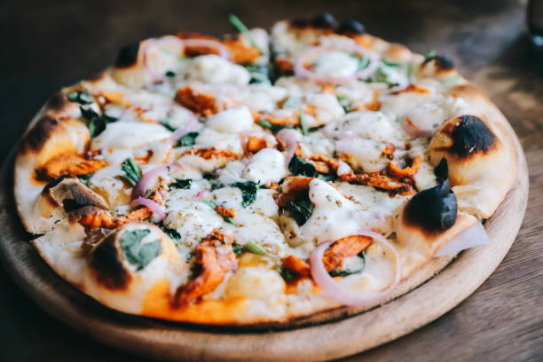 istock Tandoori Chicken Pizza on wooden table 1140489380