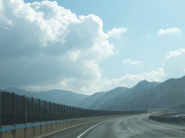 Driving on lonely highway, distant mountains, sunny day, travelling on Yamagata, Japan