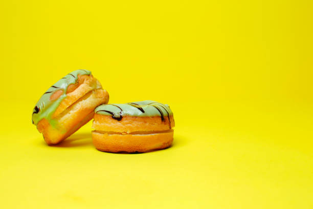 istock green chocolate donuts group on yellow background and space for your advertising. 1140492005