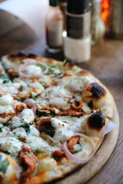 istock Tandoori Chicken Pizza on wooden table 1140492265