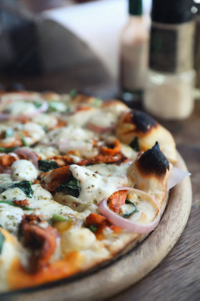 istock Tandoori Chicken Pizza on wooden table 1140492269