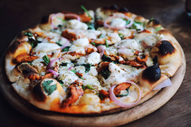istock Tandoori Chicken Pizza on wooden table 1140492271
