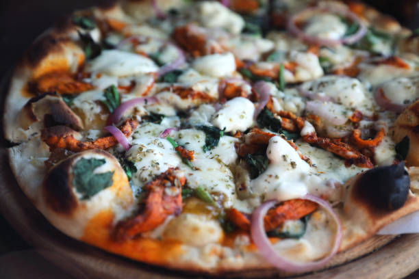 istock Tandoori Chicken Pizza on wooden table 1140492272