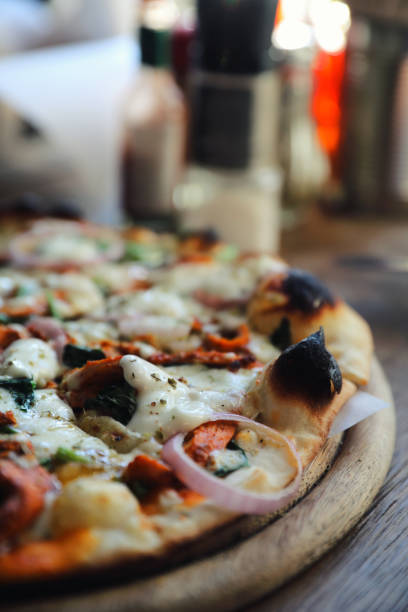 istock Tandoori Chicken Pizza on wooden table 1140492274
