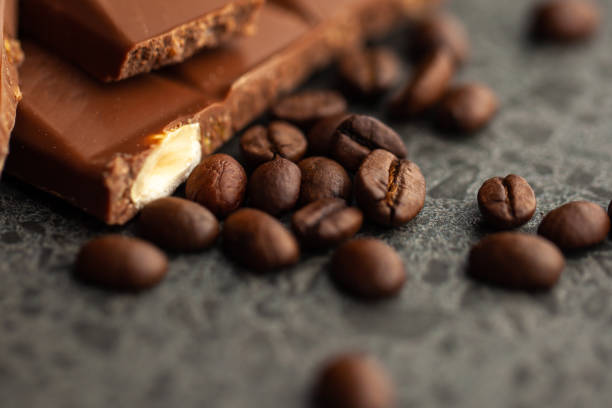 istock Coffee beans and dark chocolate glaze on gray background 1140493530