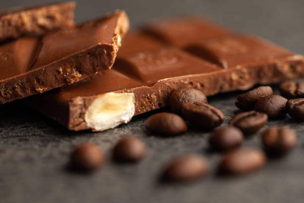 istock Coffee beans and dark chocolate glaze on gray background 1140493531