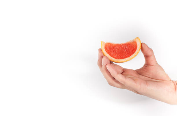 istock Hand holding fruits slice on white background 1140499071