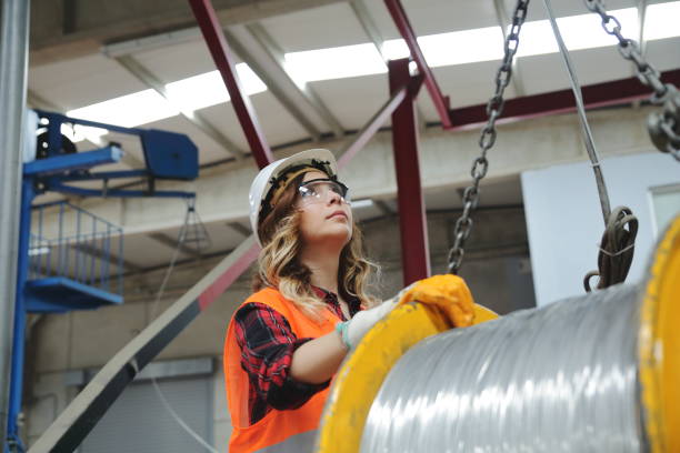 istock Young engineer woman holding and working with remote control for operating crane 1140508597