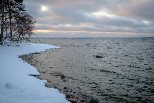 istock a beach with snow on and sunset in the background 1140508703