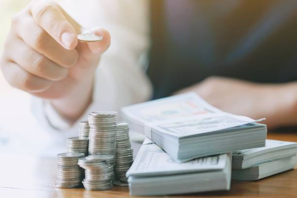 istock Businessman analyzing investment charts and pressing calculator buttons over documents. Accounting Concept. 1140510610