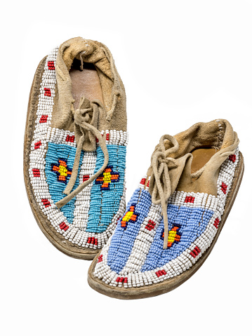 Pearl-embroidered moccasins of the North American Indians isolated on white