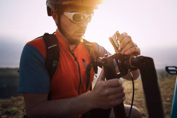 istock Cycler repairing bicycle at mountain at sunrise. 1140515868