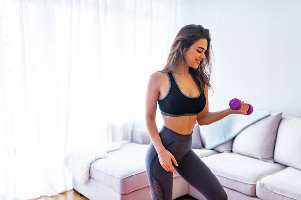 istock Sporty woman does the exercises with dumbbells. 1140517521