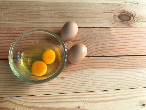 istock two fresh chicken yolk and egg white in glass cup and another two eggs beside it 1140518463