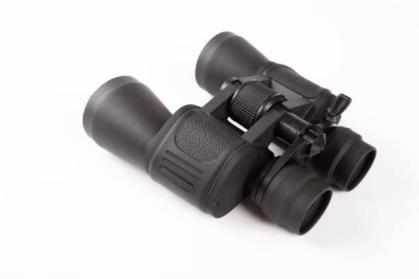 istock Black binoculars with orange lens isolated on white background 1140518535