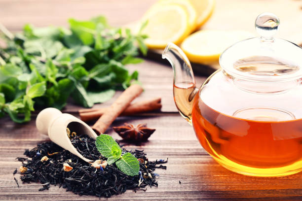 istock Glass teapot with mint leafs and cinnamon sticks on wooden table 1140519475