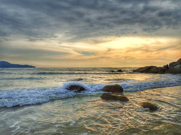 istock Beautiful sunset view on sea shore with stony background. 1140519727