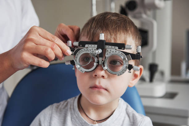 istock Little boy with phoropter having testing his eyes in the doctor's office 1140521108