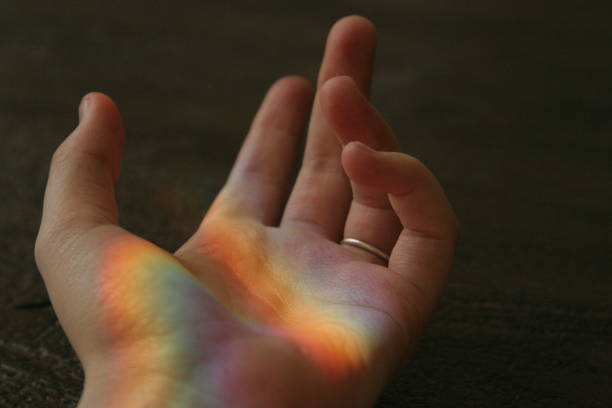 istock Open hand reaching for the distance with a ring while a rainbow is reflected on the palm of the hand 1140521812